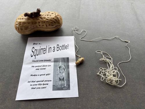 A string, a peanut, a flier advertising a joke squirrel business