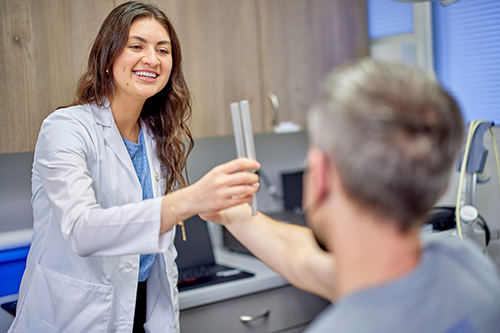 Image of a medical student treating a patient. 