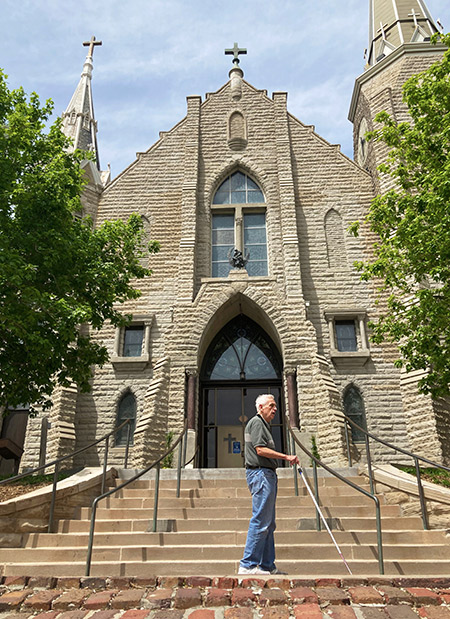 Father Larry Gillick walking in front of St. John's Church.