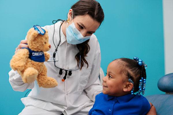 A dental student works with a pediatric patient in the School of Dentistry's pediatric clinic.