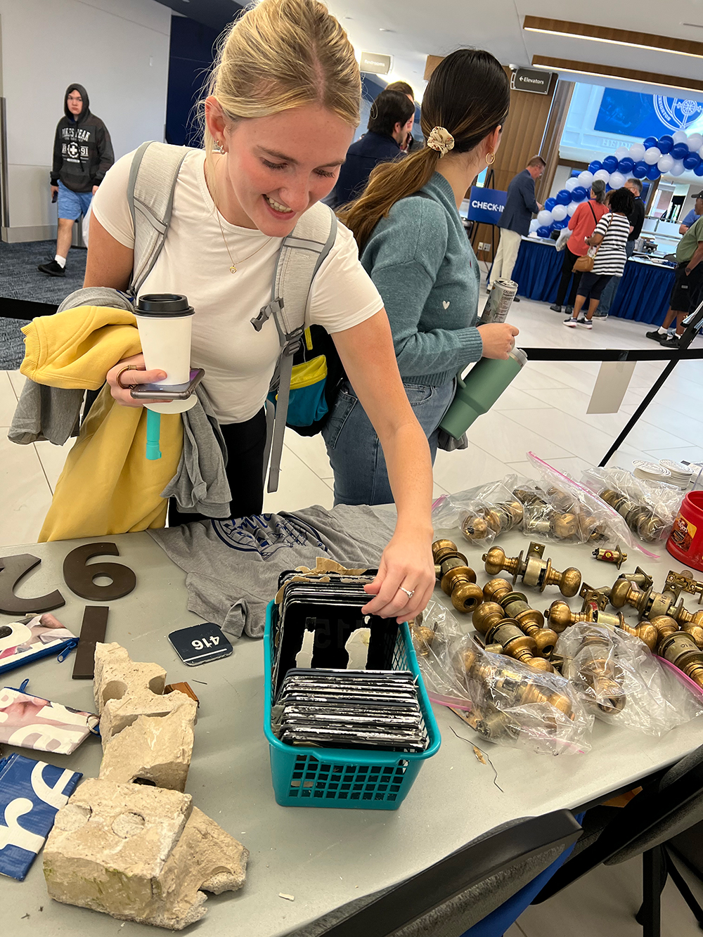 A student looks through room numbers at Gallagher Garage Sale