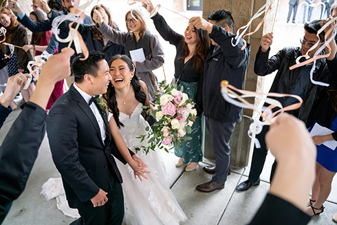 Joey and Jeannie Ngo walk through crowd after getting married. 