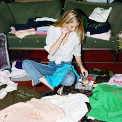 Rachelle Hruska MacPherson feature start A woman sits on the floor as she works on a stitching project