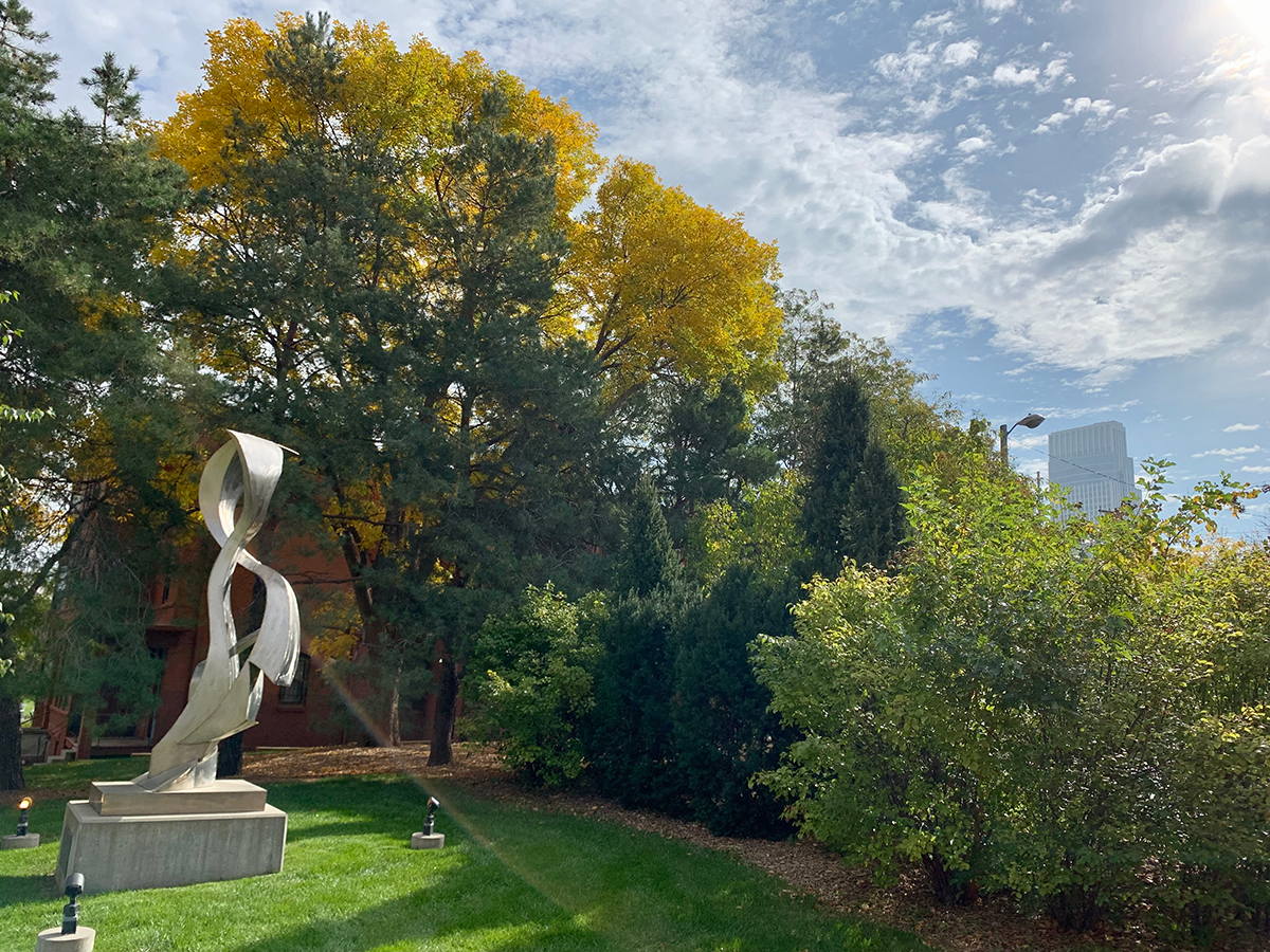 fall foliage by statue near Opus Hall