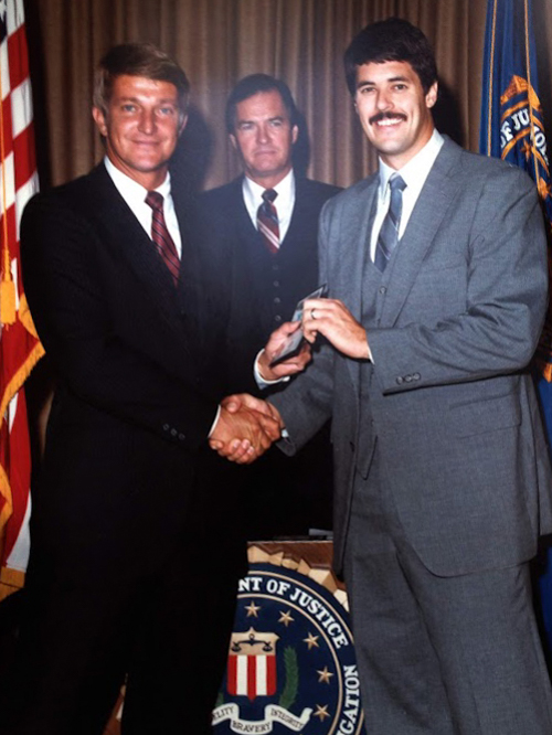 Trom, right, receives his FBI credentials upon graduating in 1983.