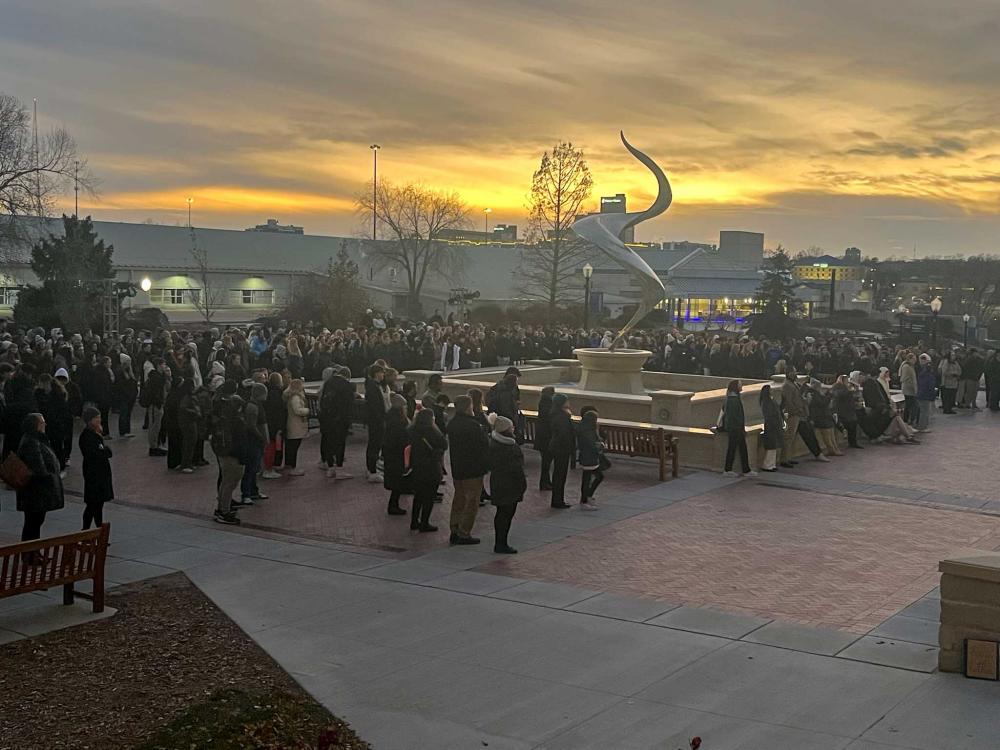 Students gather at the fountain to celebrate the lighting of campus