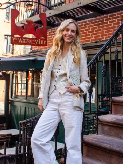 Rachelle Hruska MacPherson feature portrait A woman smiles as she stands next to a set of steps