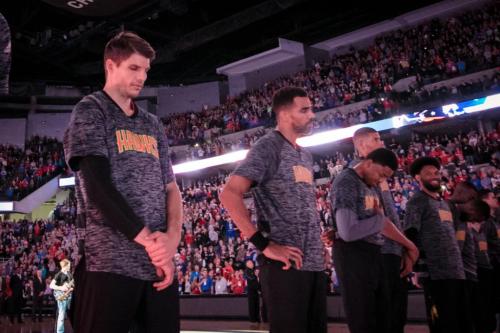 Kyle Korver stands in a line with his teammates before a 2016 exhibition game