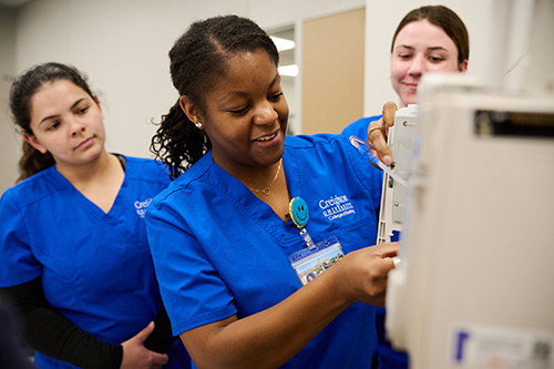 Nursing students working on equipment