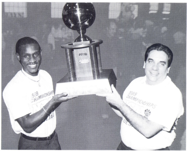 James Farr, BA'89, and Coach Tony Barone hold the MVC Championship trophy at a rally in the Old Gym.