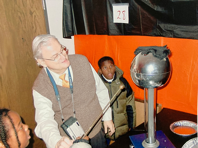 Dr. Zepf shows two children a trick/exhibit in the Haunted Lab.