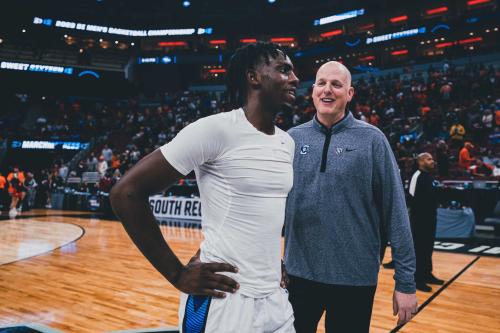 A coach talks to a basketball player