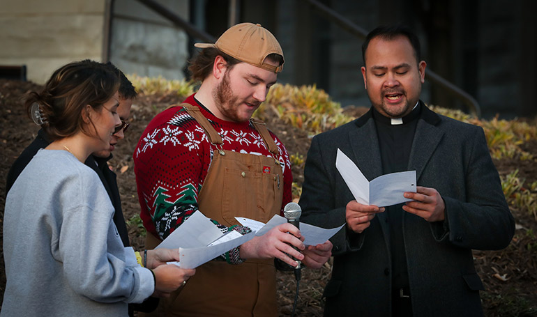 Staff and students sing at the Celebration of Light ceremony.