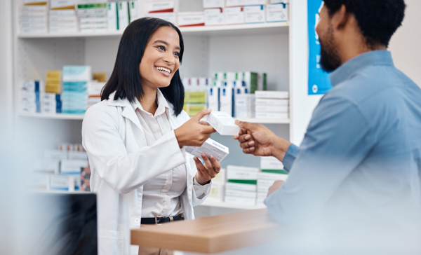 A pharmacist helps a patient.