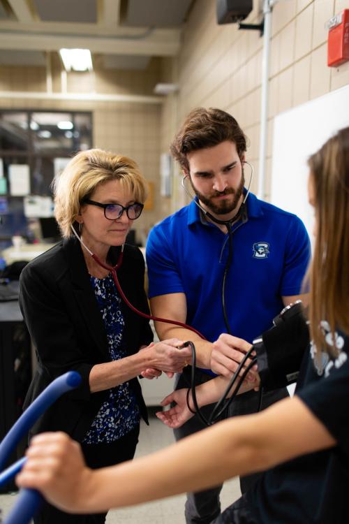 Two exercise science professionals examine a patient
