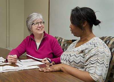 Julie Kalkowski works with a client in the Financial Success Program.