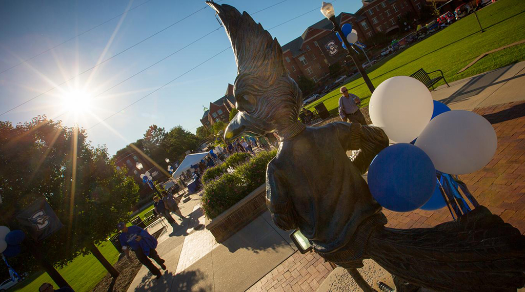 Billy Bluejay statue with white and blue balloons 