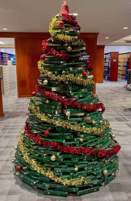 A Christmas tree built out of green books