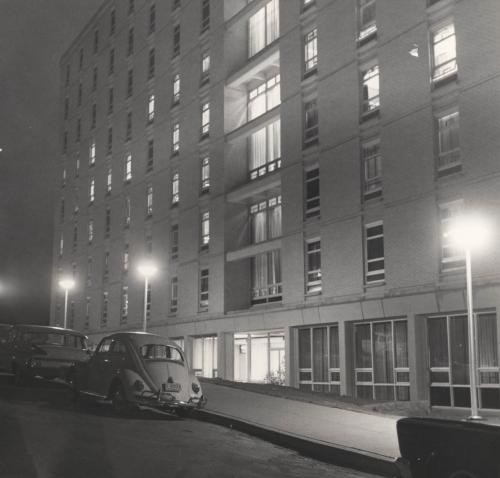 A photo of the exterior of Kiewit Hall at night in 1966