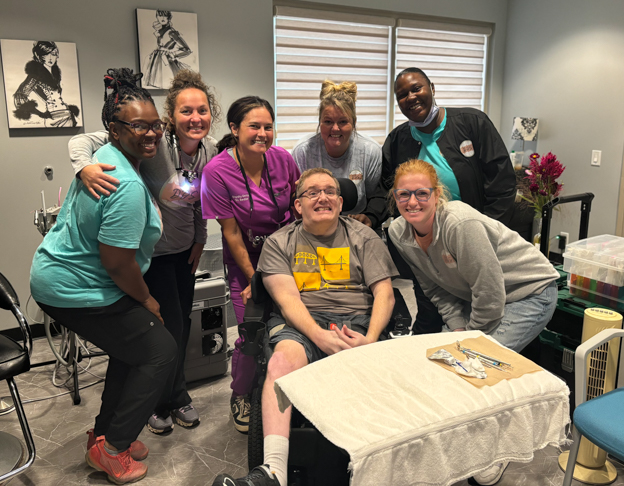 Sedillo, top center, with the team at QLI rehabilitation center in Omaha.