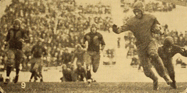 A Creighton football player runs the ball in this vintage photo.