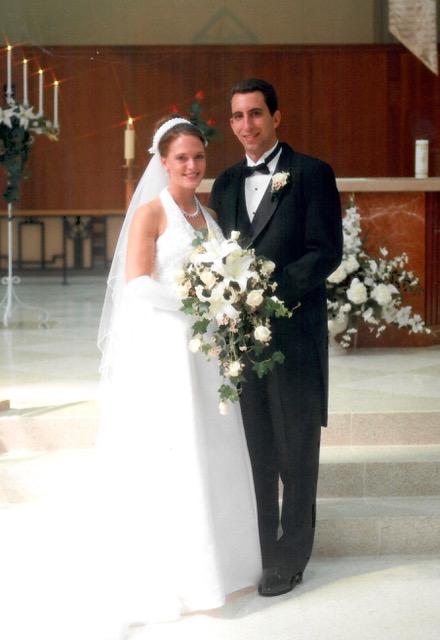 Jodi and John Conti pose for a photo at their wedding.