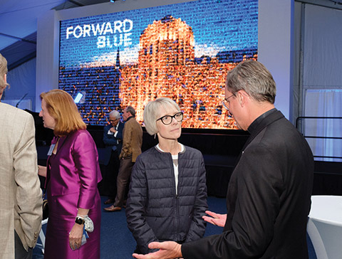 Cindy Heider, center, speaks with Creighton President Daniel S. Hendrickson, SJ, PhD.