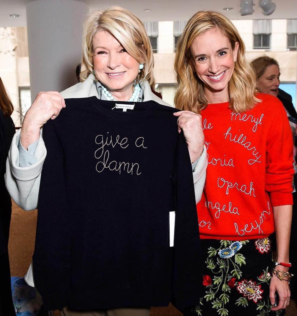 Two smiling women stand next to each other for a photo