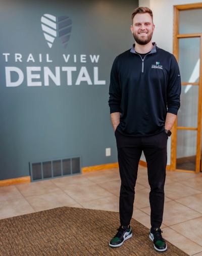 A dentist in his practice's lobby