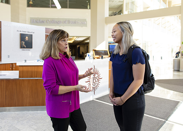 Debbie Wells speaks with a student