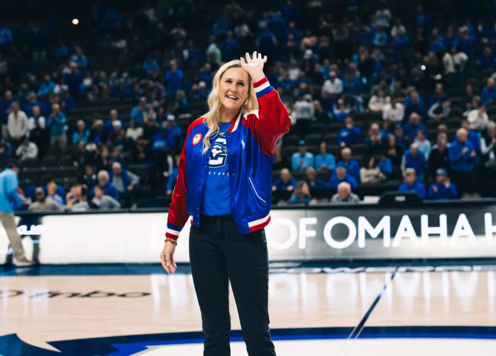 A woman waves to the crowd