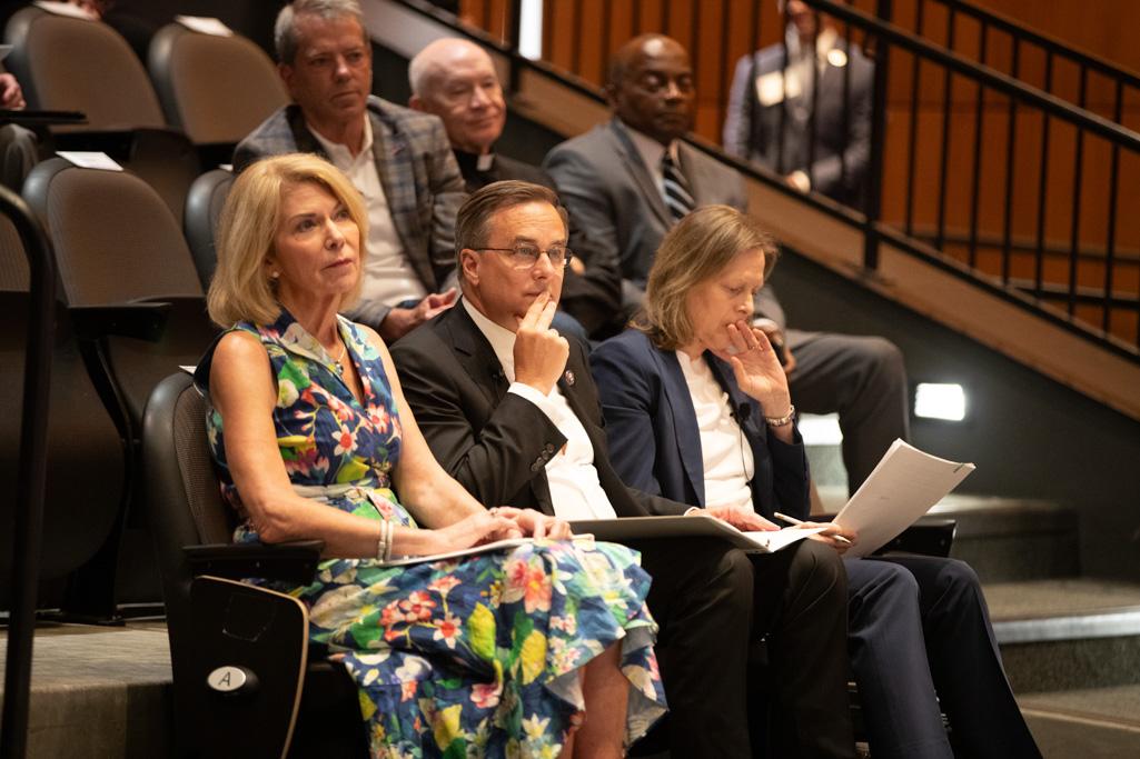 Dignitaries sit and listen at the start of a conference