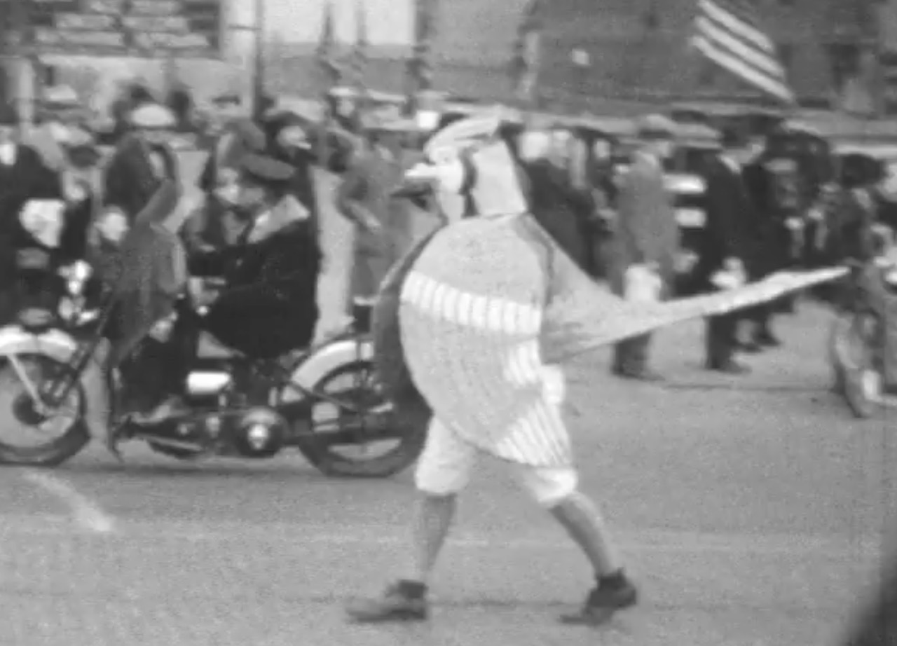 Billy Bluejay walks in the homecoming parade in 1937.