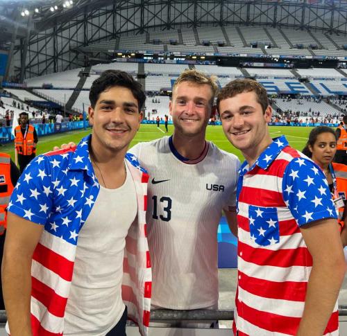 A U.S. Olympic Team soccer player poses for a photo with two college teammates