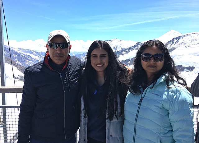 The Malhotra family pictured by the mountains