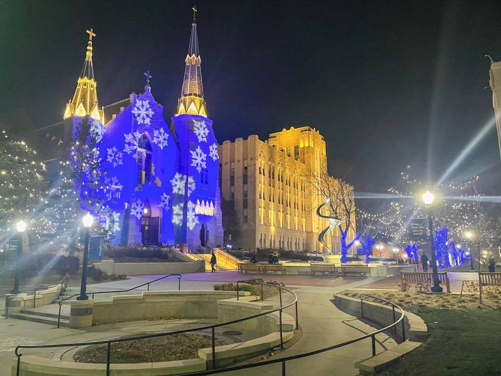 A church and an administrative building illuminated for Christmas