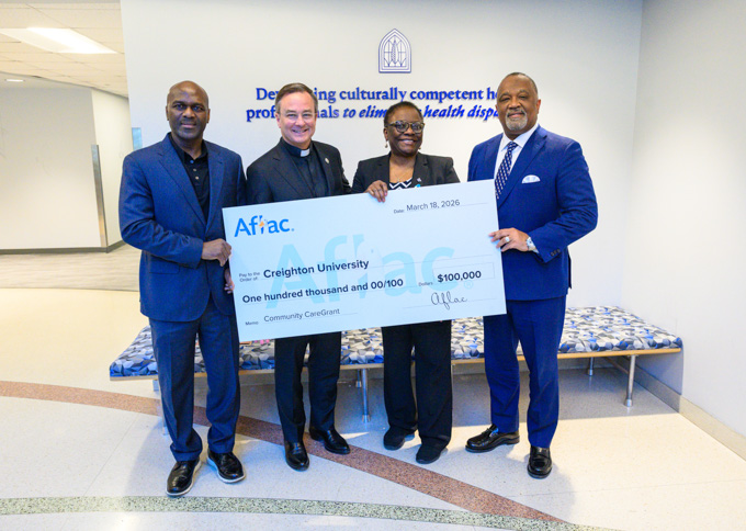 Pictured from left: Sal Issaka, department director at Omaha Housing Authority; Creighton President the Rev. Daniel S. Hendrickson, SJ, PhD; Sade Kosoko-Lasaki, MD, professor in the School of Medicine; and Virgil Miller, president of Aflac United States.