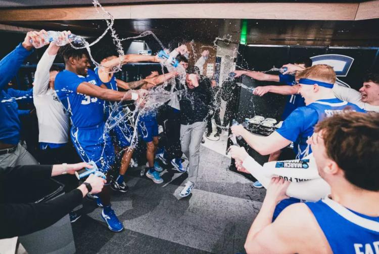 A team celebrates a big win in the locker room