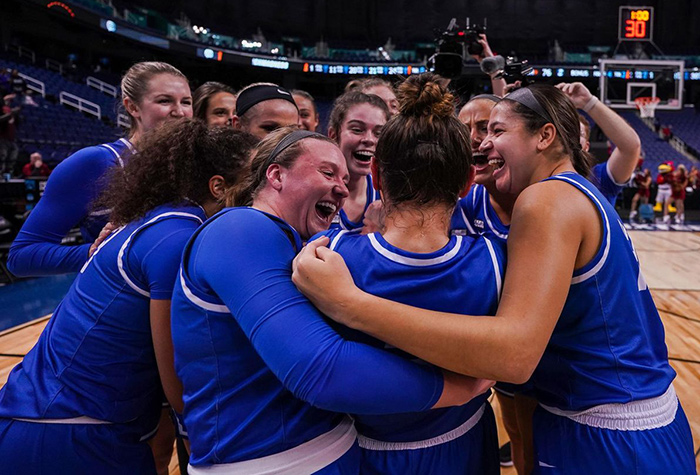 Women's basketball team celebrates after a win