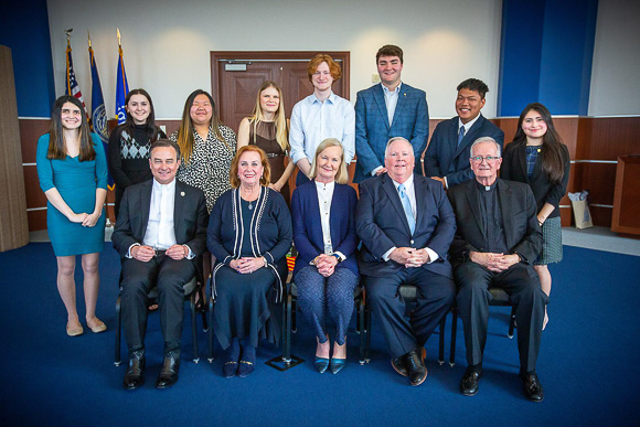 Betsy and Chris Murphy, seated next to Fr. Lannon in the front row, pictured with a cohort of Lannon Leadership Scholars.