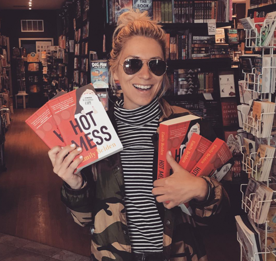 Emily holding copies of her book.