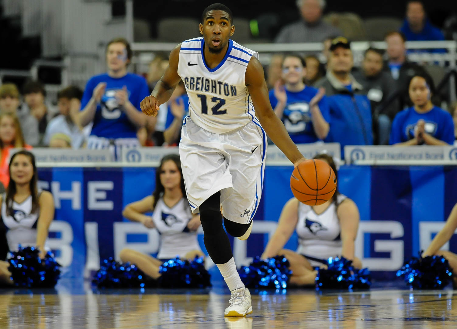 Jahenns Manigat dribbles a basketball up the court