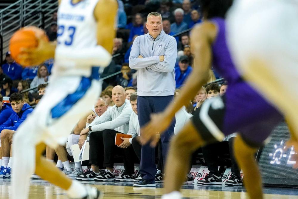 A coach watches his team play