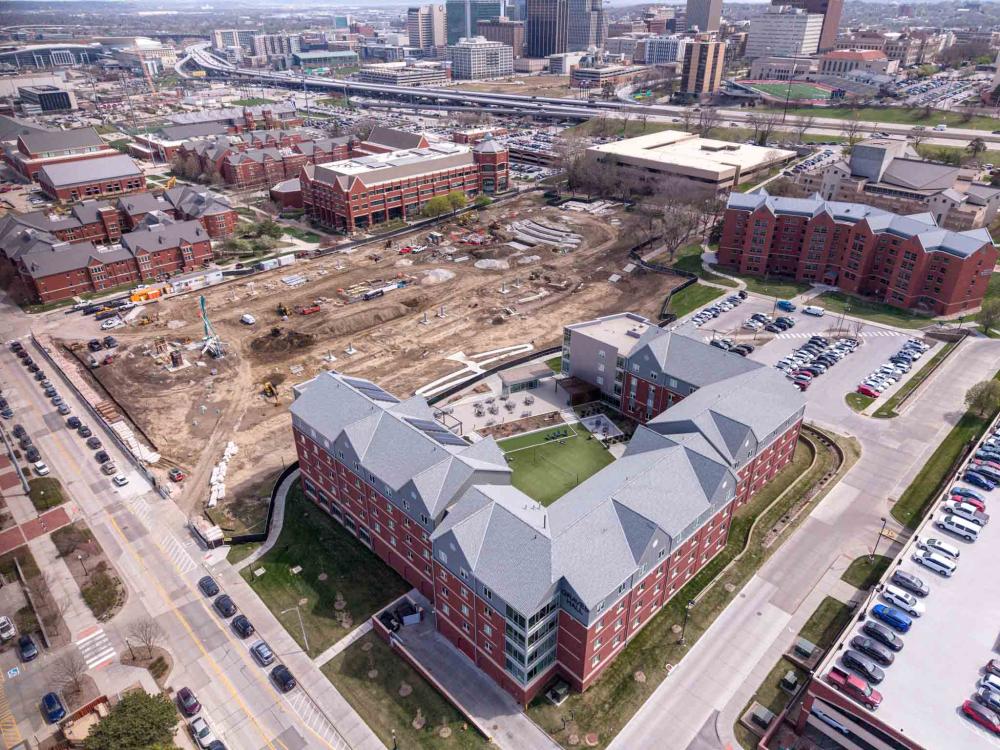 Aerial photo of a large patch of dirt and campus buildings