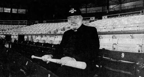 Creighton president with a baseball bat