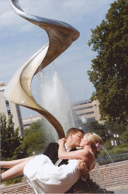 Chris Codak Simpson kisses Jennifer Simpson in front of the St. John's Fountain.