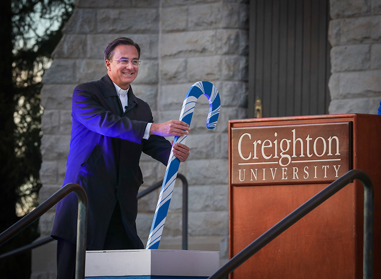 Fr. Hendrickson flips the switch at the Celebration of Light ceremony.