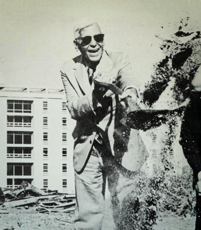 Peter Kiewit shovels dirt at the fitness center groundbreaking.