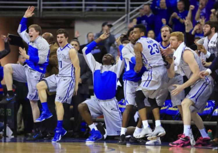 Players celebrate on the bench during a basketball game