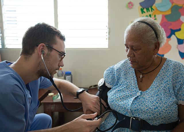 A medical student cares for a patient